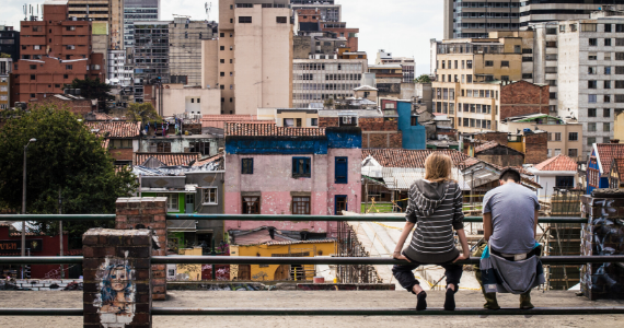 two people sitting in a Bogota slum
